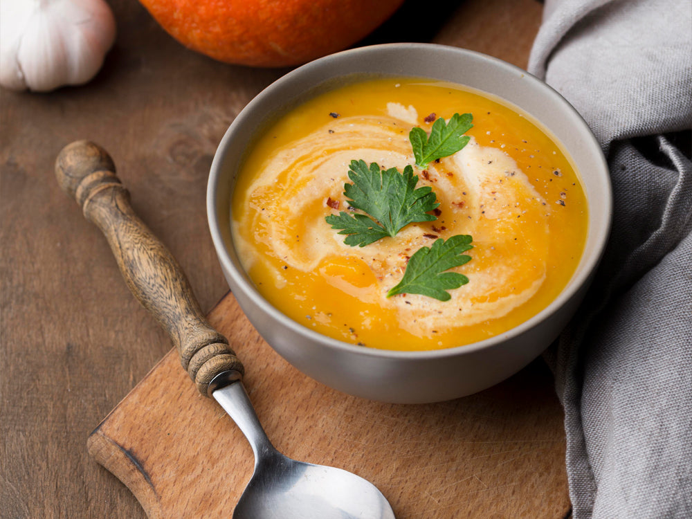 Bowl of creamy squash soup with herbs