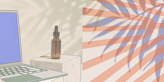 A THC tincture bottle next to a laptop used to buy THC tincture online.