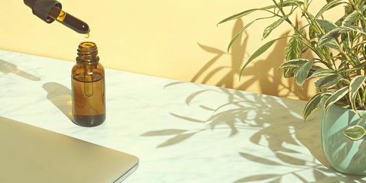 A dropper bottle of CBG oil on a table, used to experience its wellness effects.