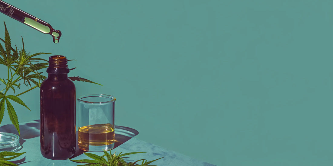 CBG oil in an amber bottle with a dropper and hemp leaves.