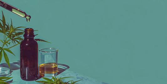 CBG oil in an amber bottle with a dropper and hemp leaves.