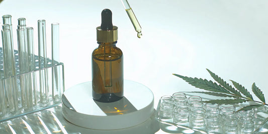 A review of CBG oil showing a dropper bottle, cannabis leaf, and lab equipment.