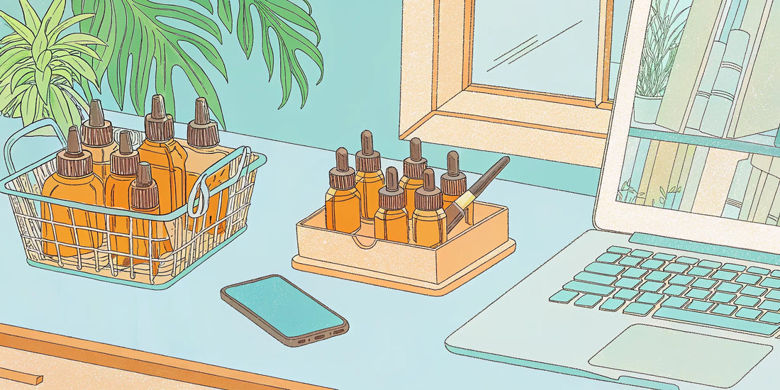 CBN oil dropper bottles beside a laptop and phone used for researching where to buy CBN oil.
